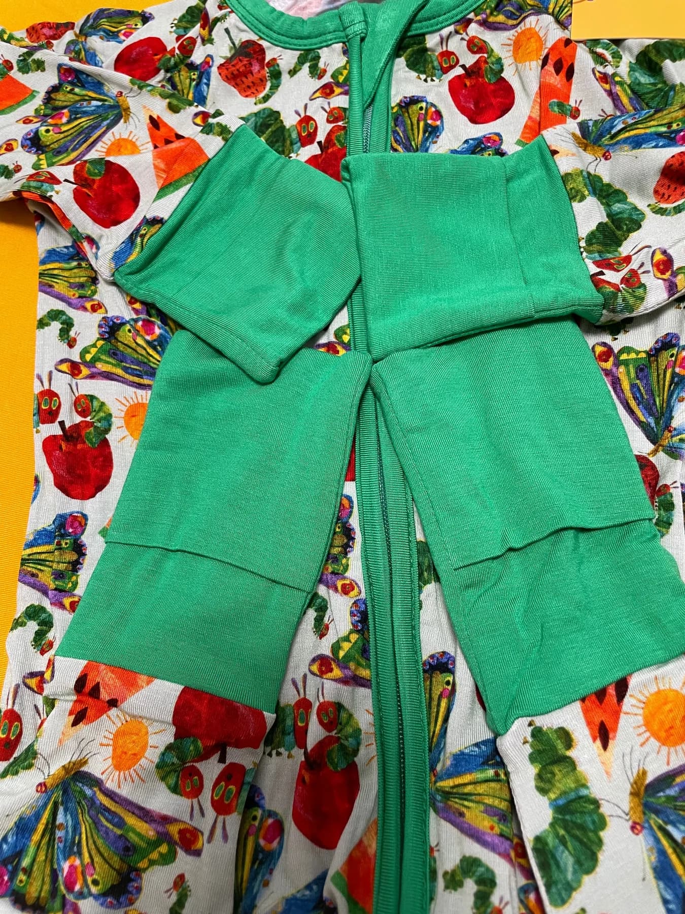 Fold-over mittens and convertible foot cuffs on a bamboo viscose baby romper
