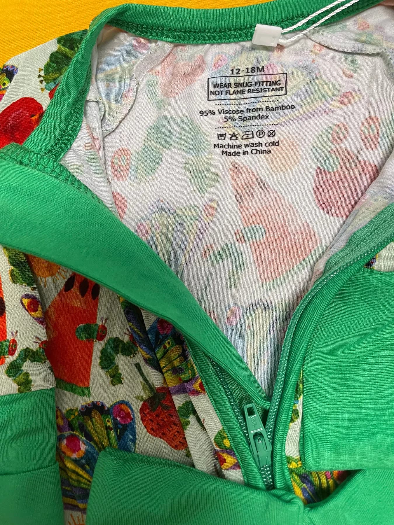 Two-way zipper and guard detail for a private label baby zippy